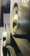 Under-hood view of serpentine belt and A/C compressor