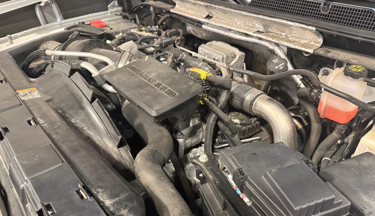 Technician performing Duramax diesel diagnostics on a GM truck