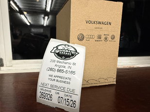 Vehicle maintenance reminder and oil change service being performed